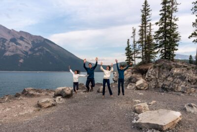 Lake Minnewanka Family Photoshoot, family jumping up in the air.