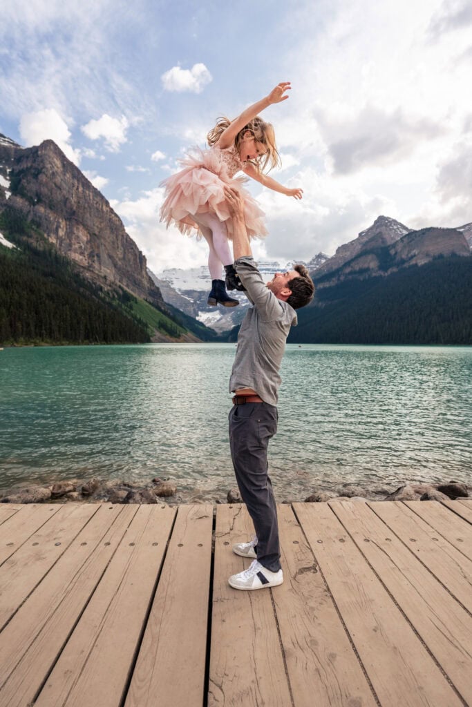 Lake Louise family photoshoot. Dad throwing daughter in the air. Lauren Hollamby Photography.