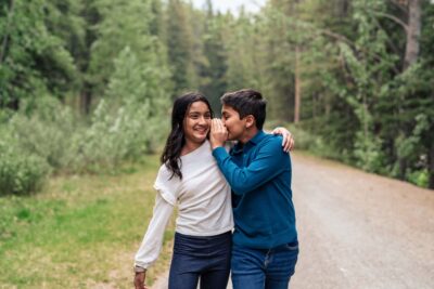Family Photoshoot at Lake Minnewanka, Banff. Kids whispering and laughing.