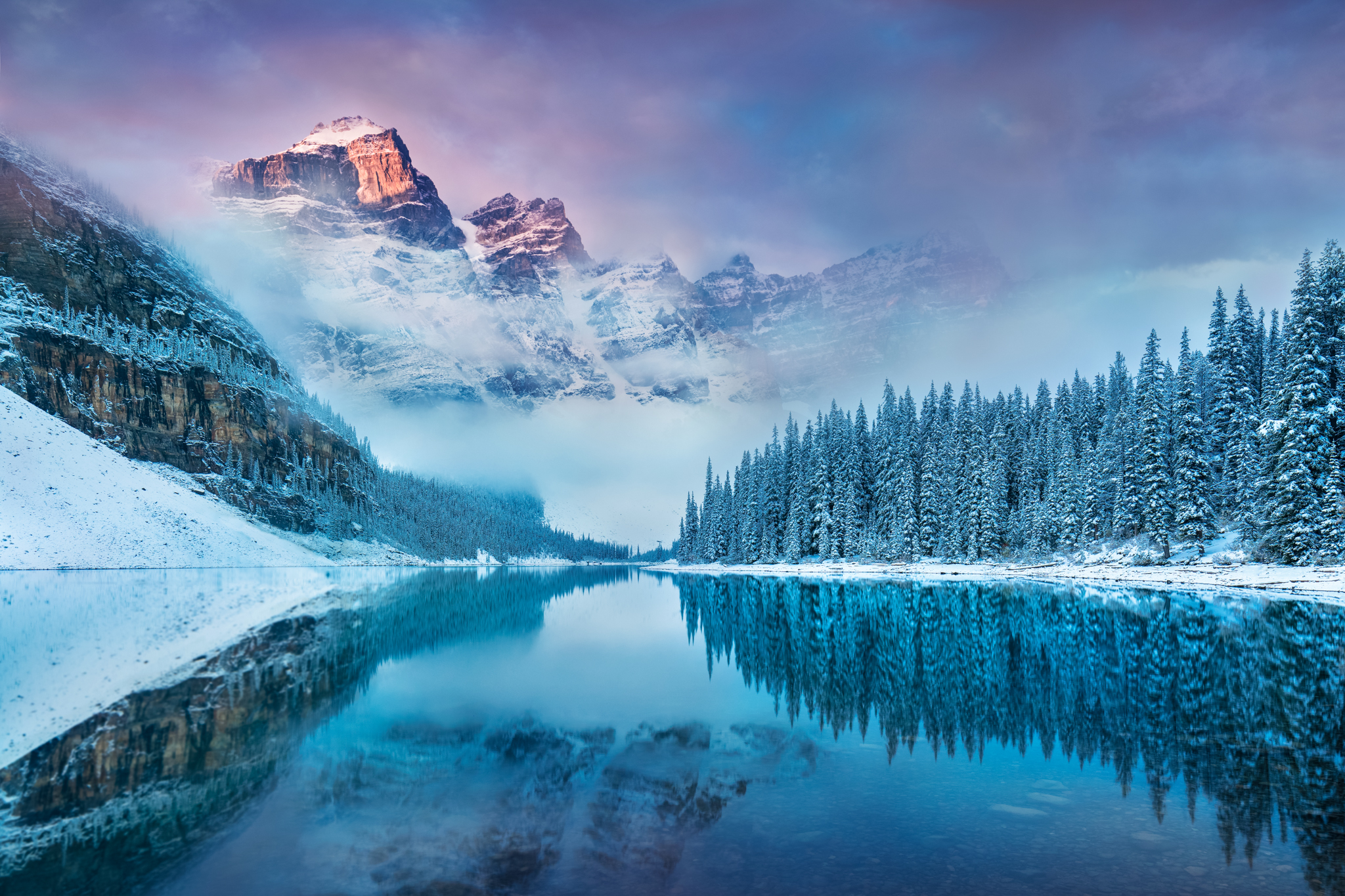 Breathtaking view of Moraine Lake with rugged snow capped peaks