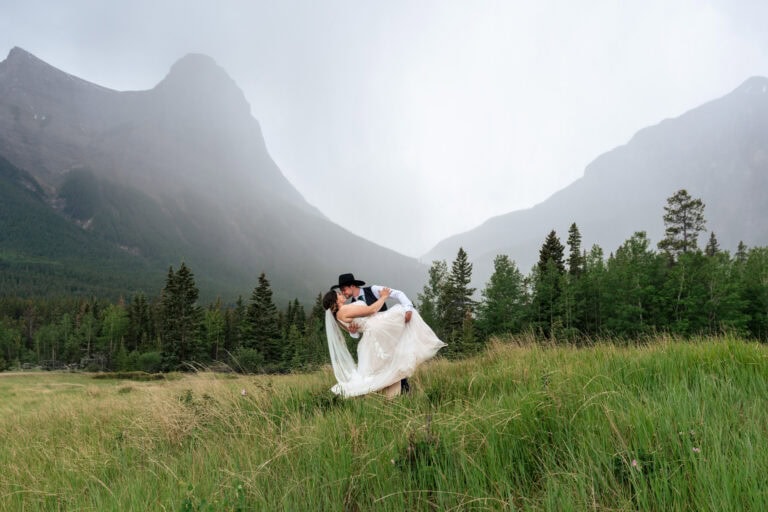 Bride and Groom dip in the rain. Canmore wedding photographer, Lauren Hollamby Photography